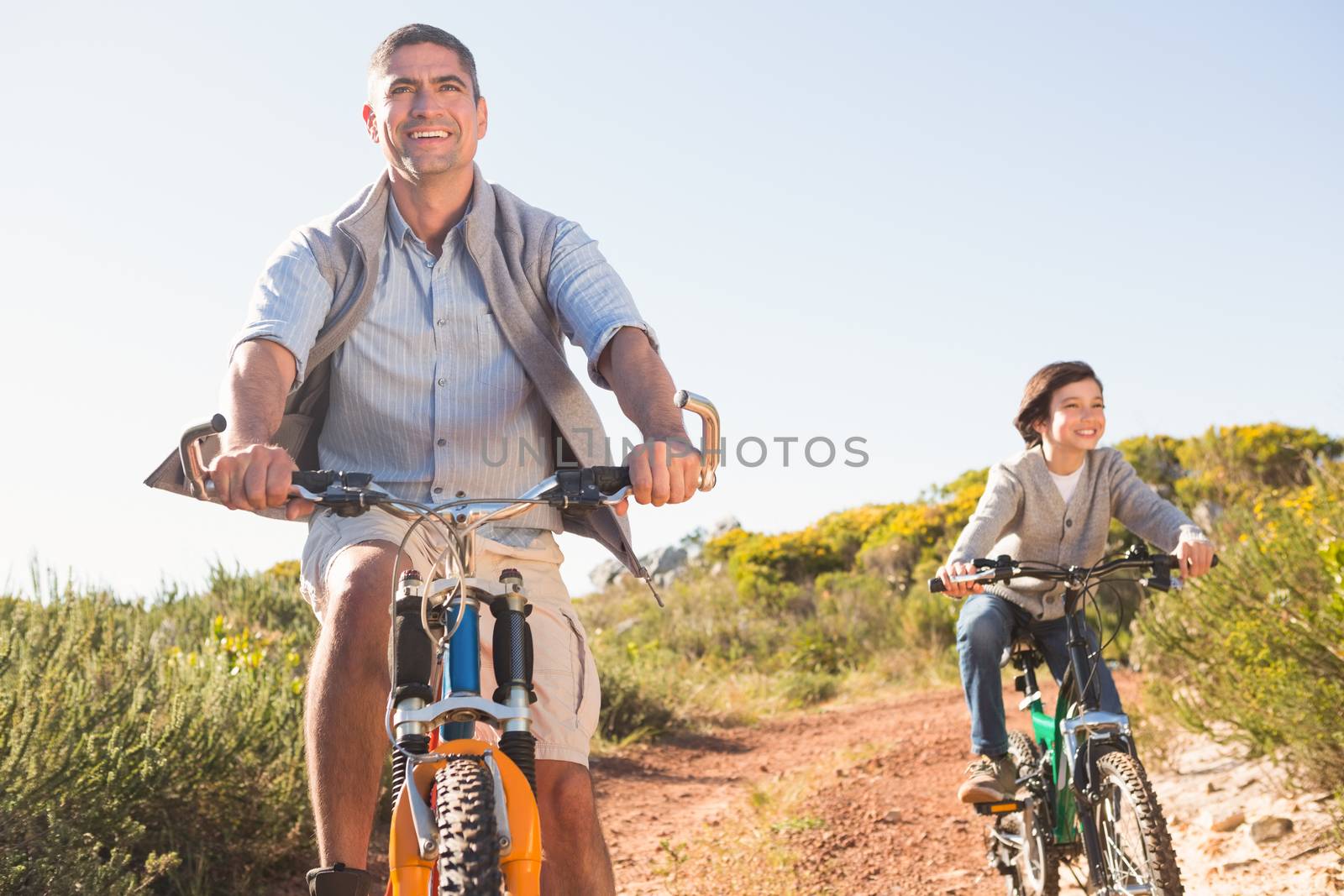 Father and son on a bike ride  by Wavebreakmedia