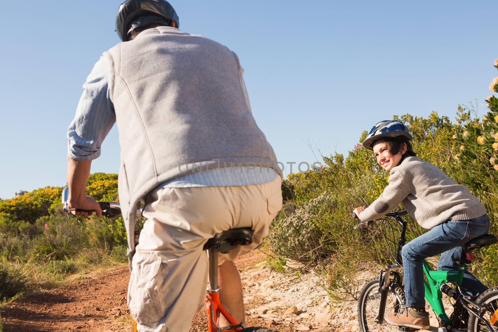 Father and son on a bike ride on a sunny day