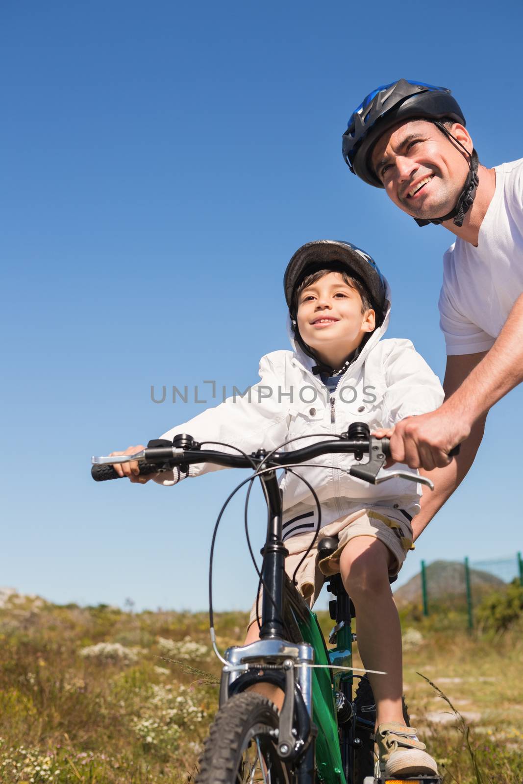 Father and son on a bike ride on a sunny day