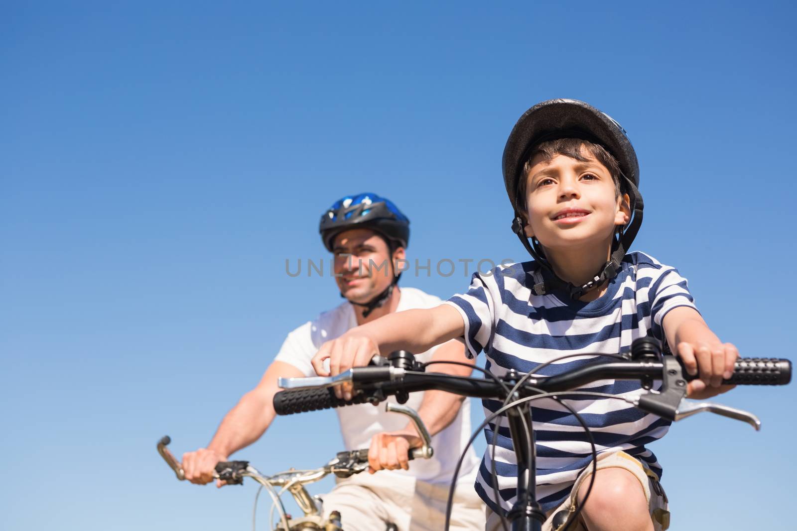 Father and son on a bike ride  by Wavebreakmedia