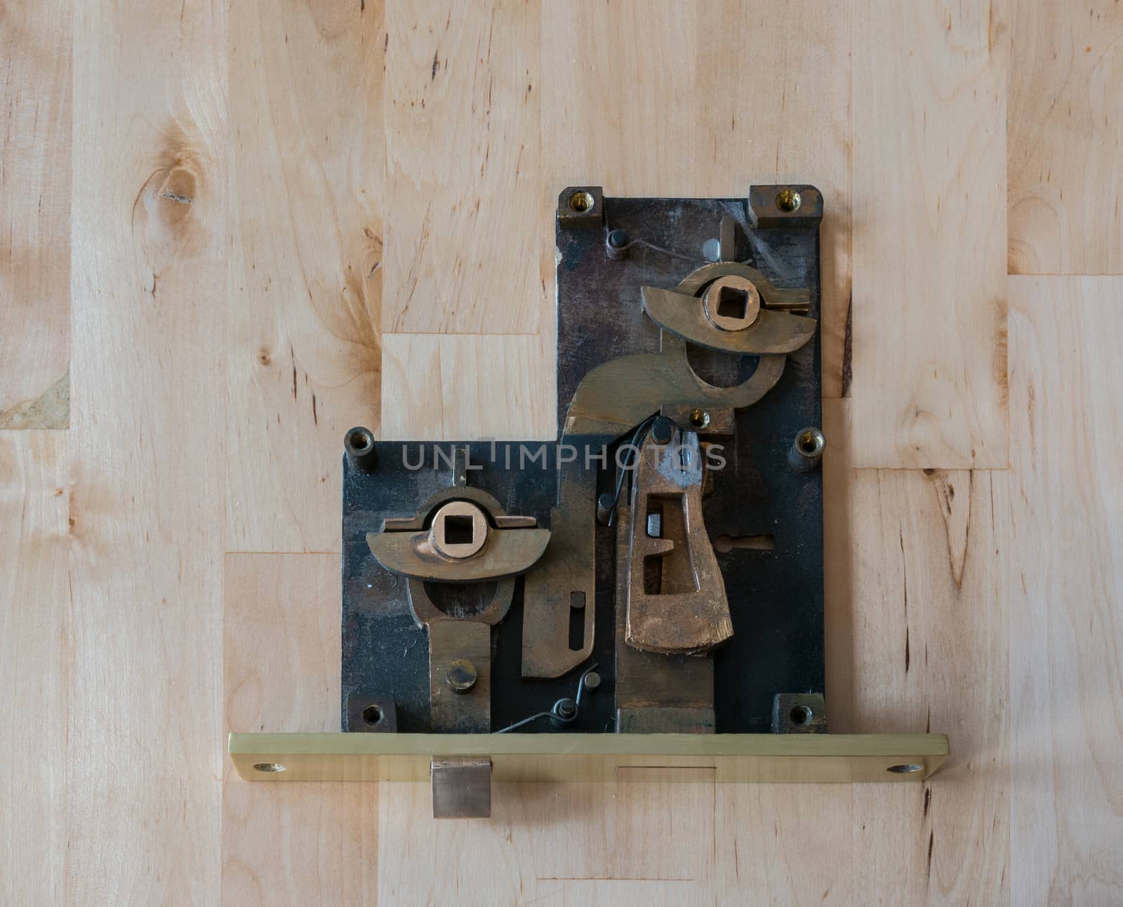 Inside view at opened old brass lock on the wooden table