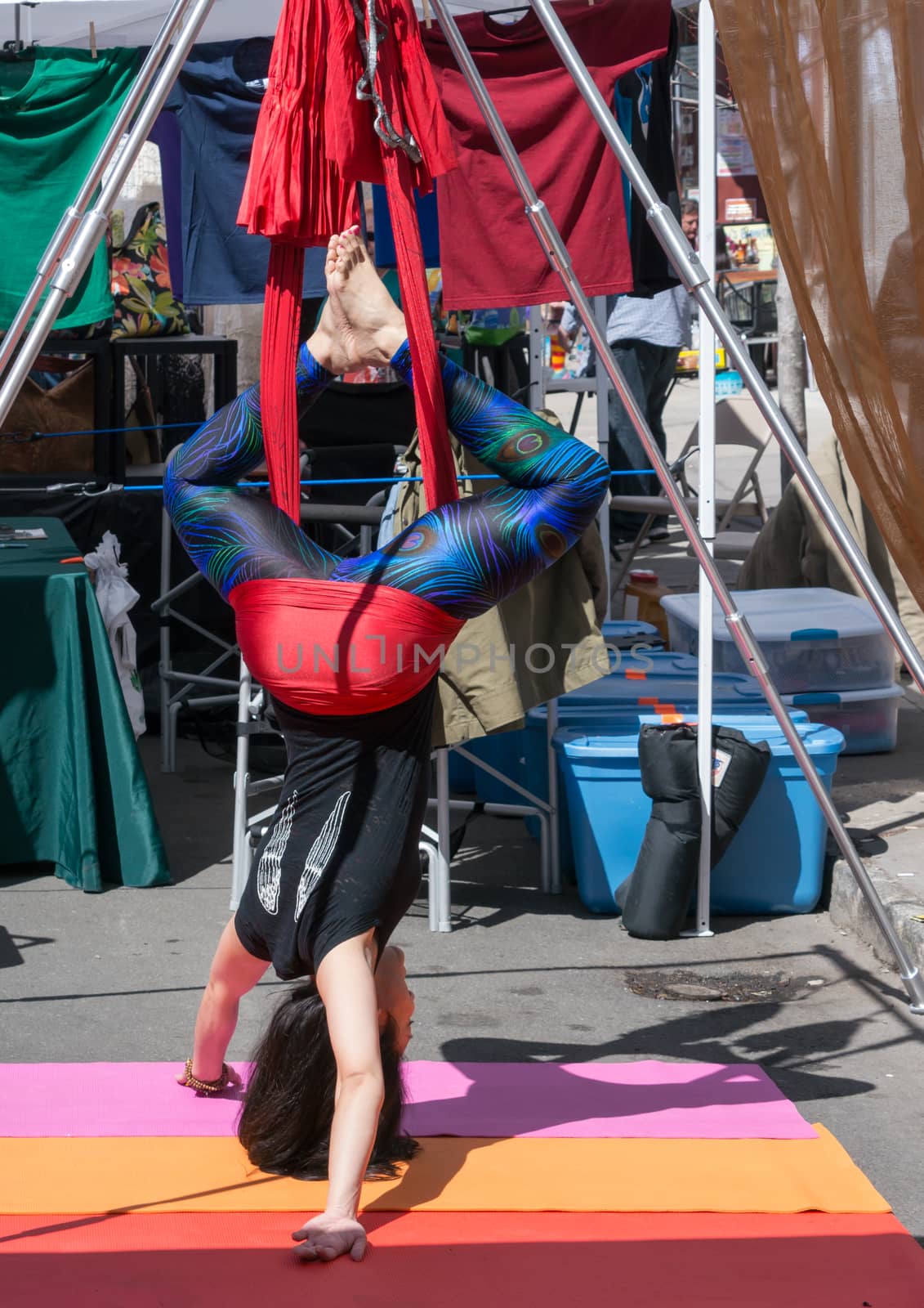 Acrobat women in upside down position at 2015  Nyack Spring Festival - April 12