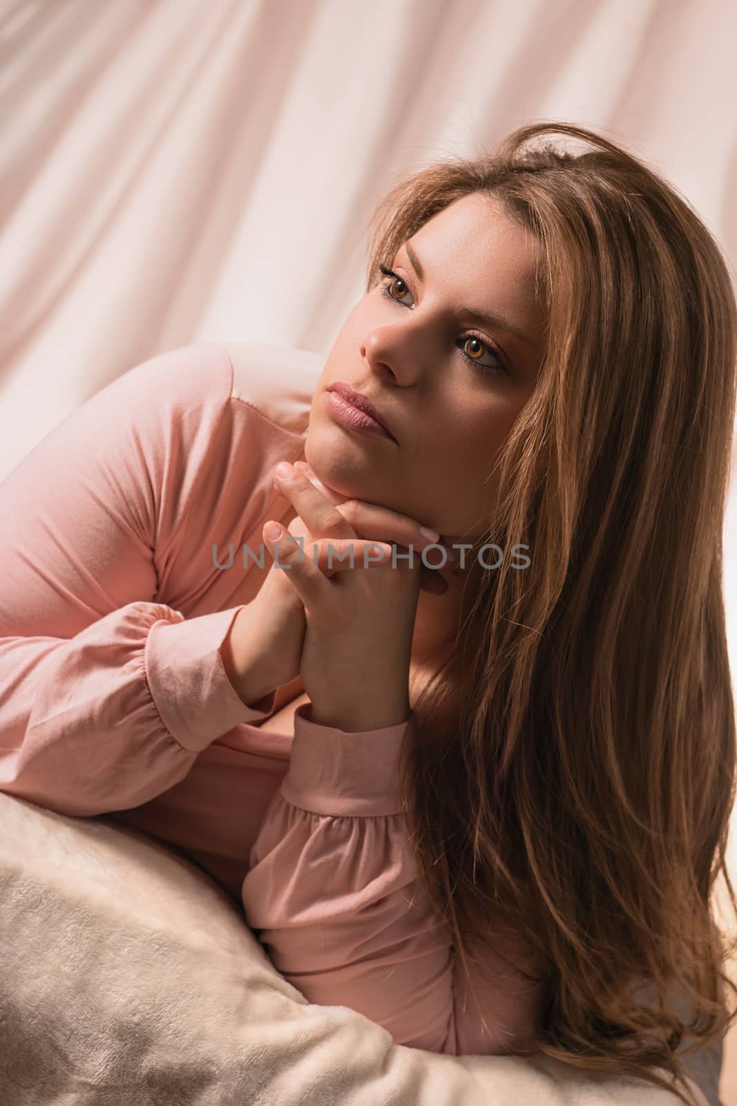 beautiful girl posing with hands supporting his chin