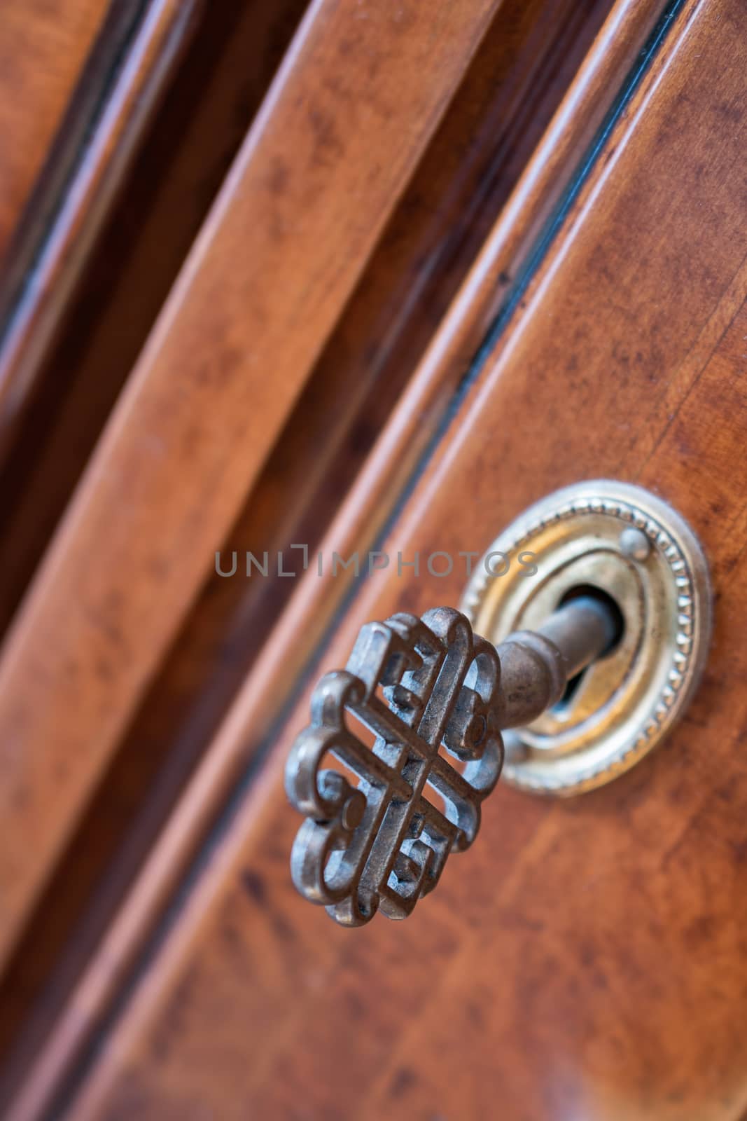 closeup of old iron key in the lock