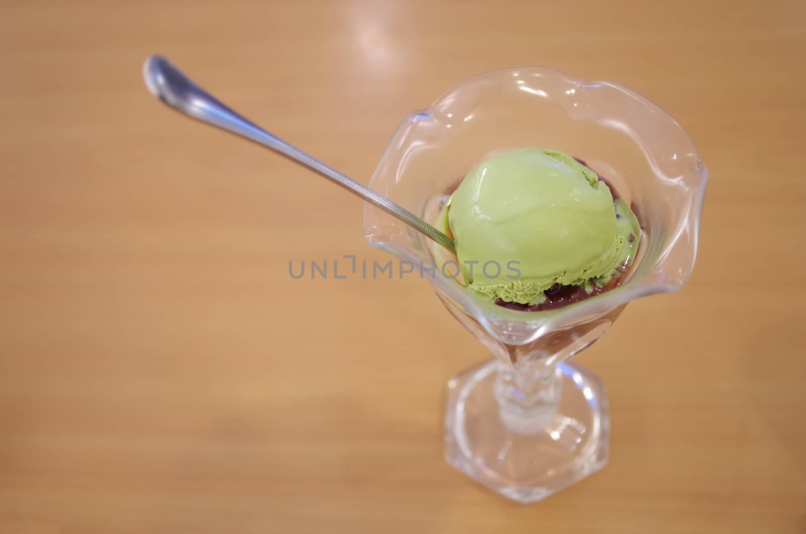 Green tea ice-cream with spoon on table in Japanese style