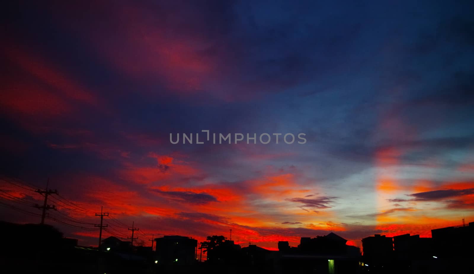 Nice sunset light shine on the sky with city silhouette by pixbox77