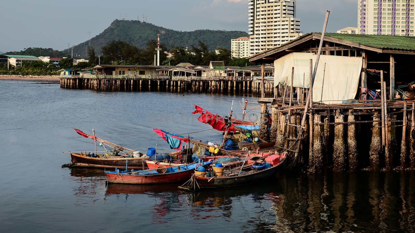 Fishing boat parking at house beside sea