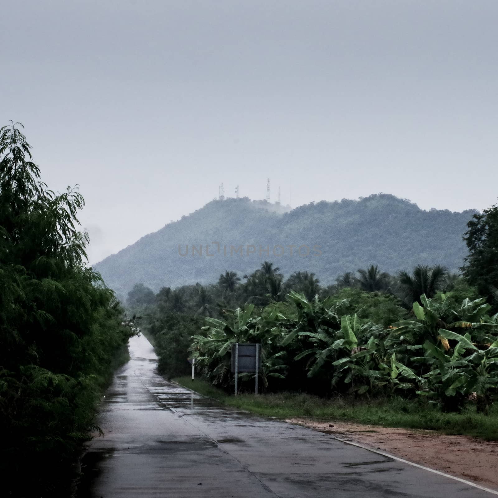 Wet road with raining sky by pixbox77