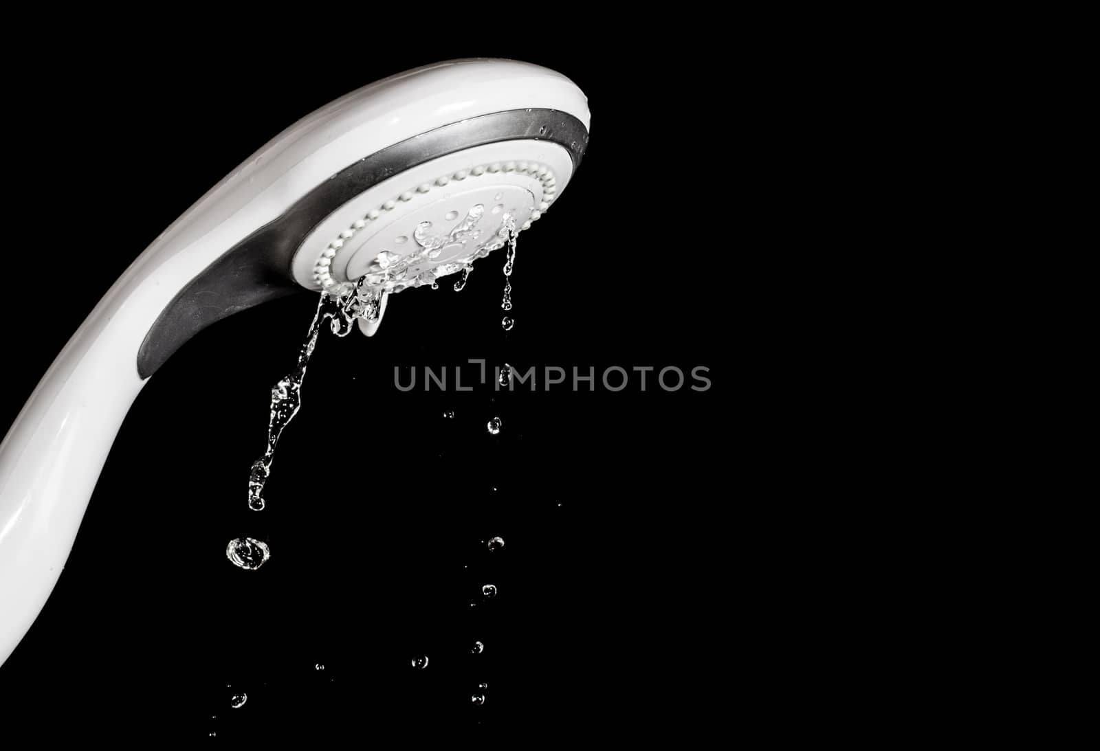 Modern shower head  with running water  isolated on black backgr by pixbox77