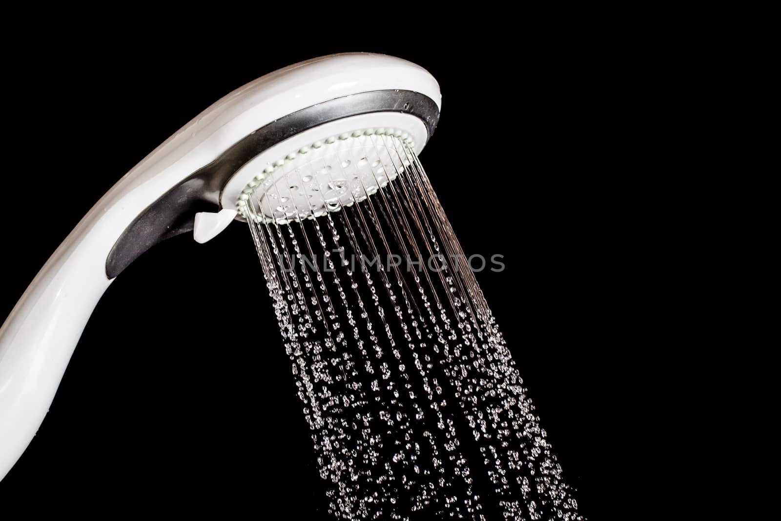 Modern shower head  with running water  isolated on black background