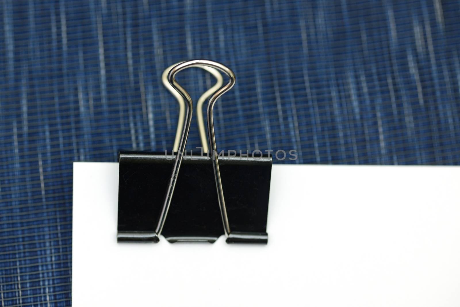 Black clerical clip for paper on white background