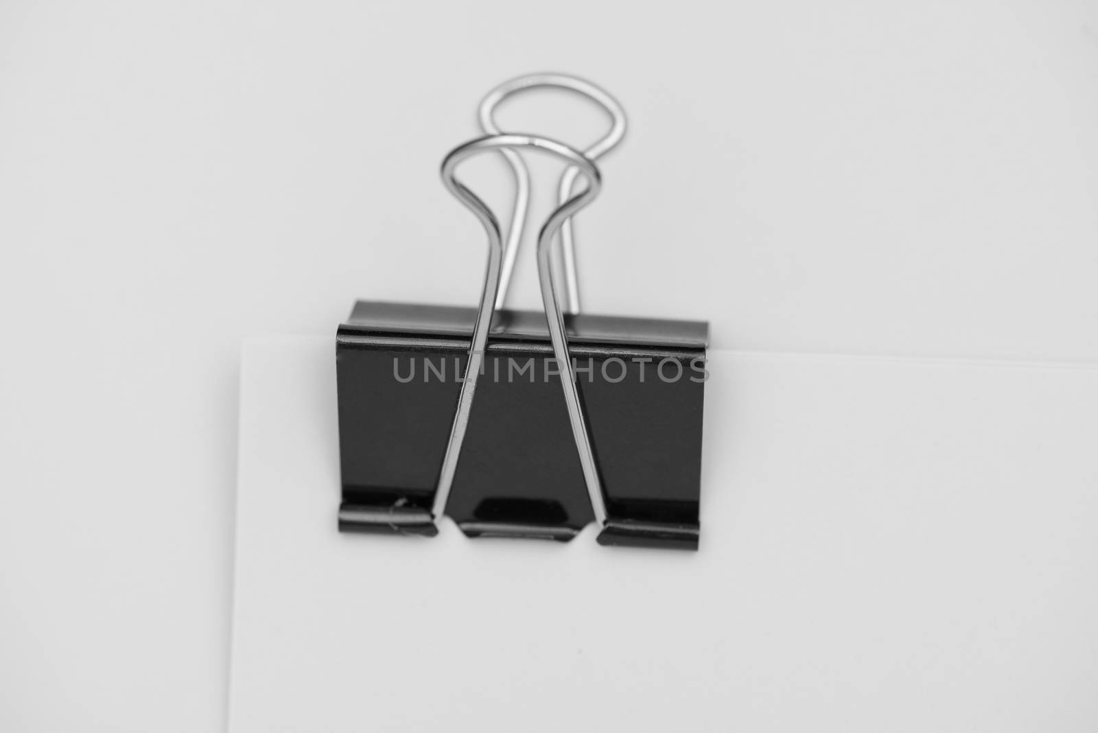 Black clerical clip for paper on white background