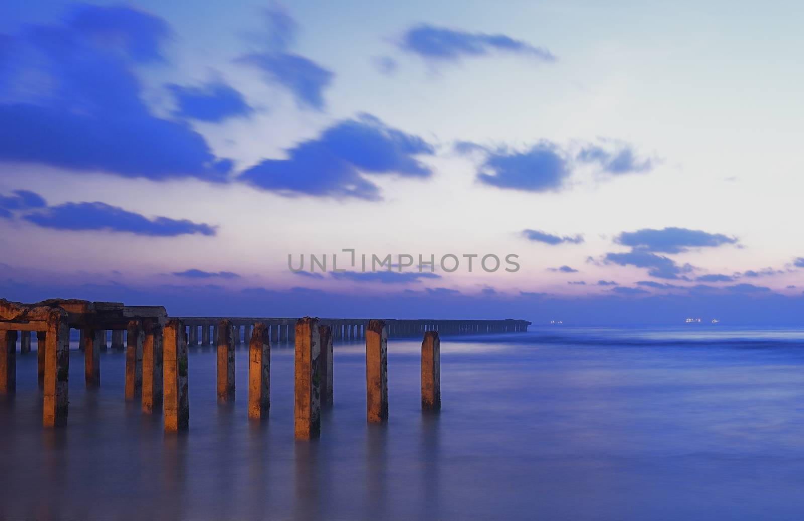 Broken Pier during sunrise on a winter day