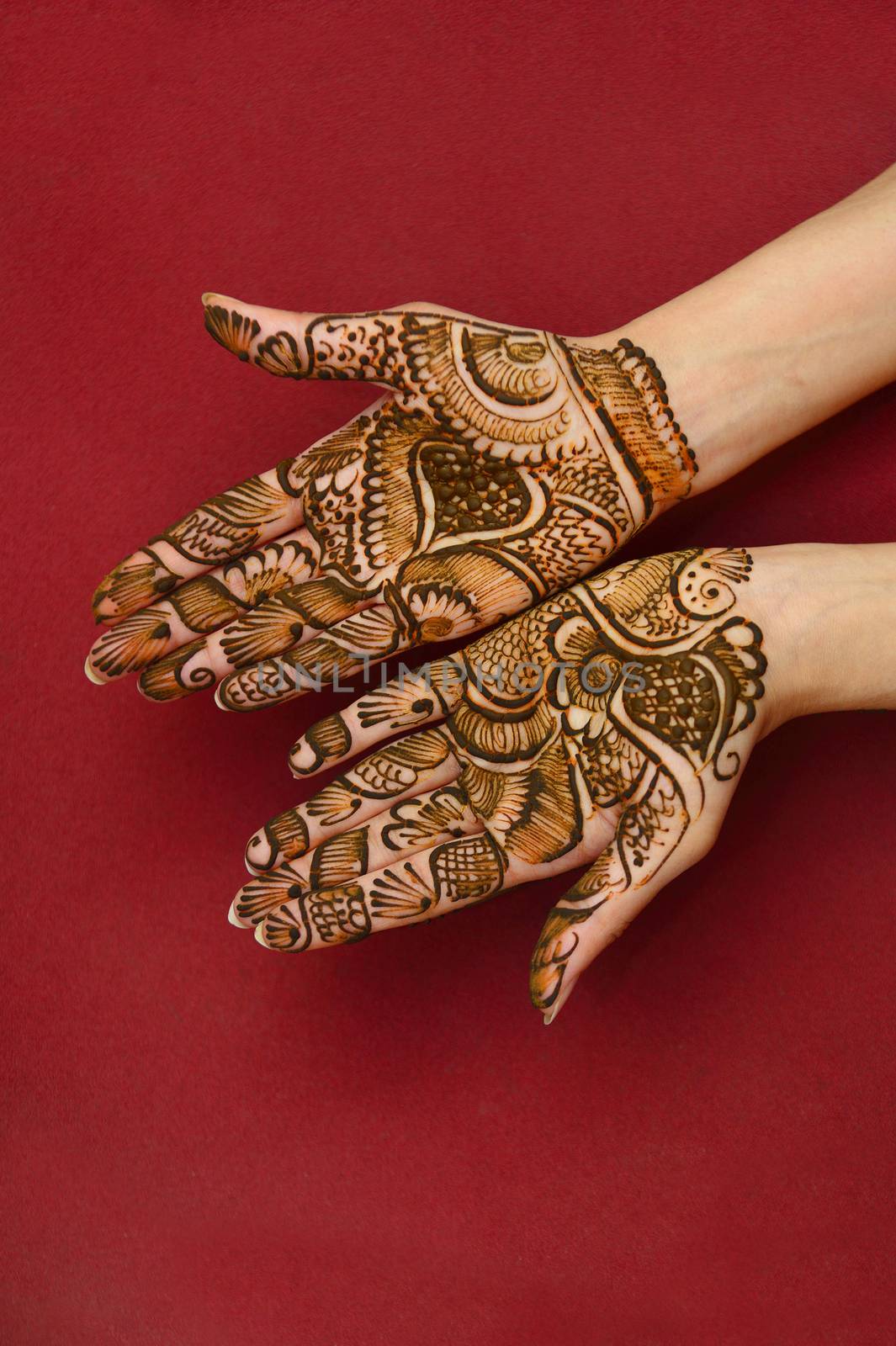 beautifully decorated indian hands with mehandi typically done for weddings