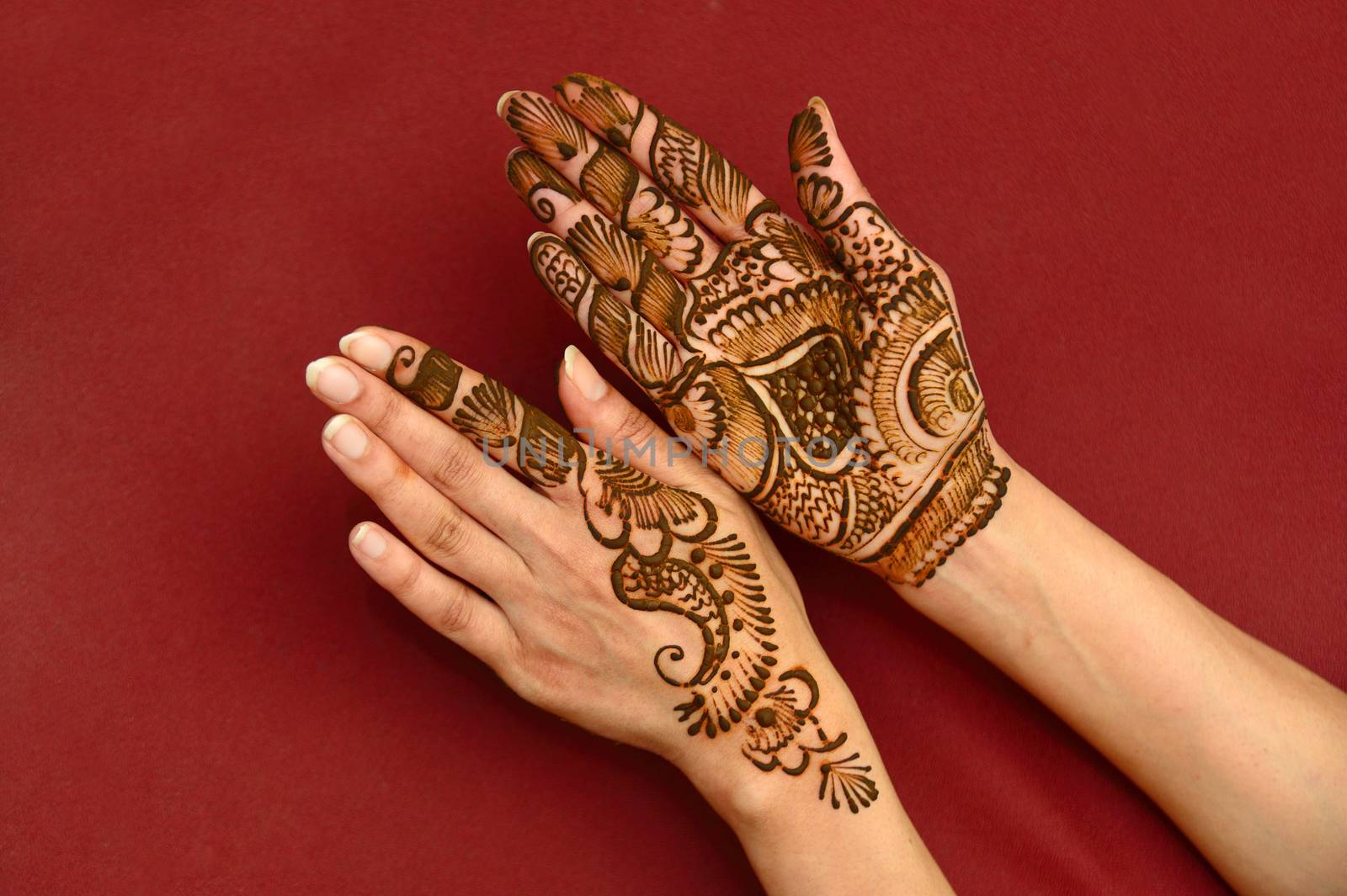 beautifully decorated indian hands with mehandi typically done for weddings