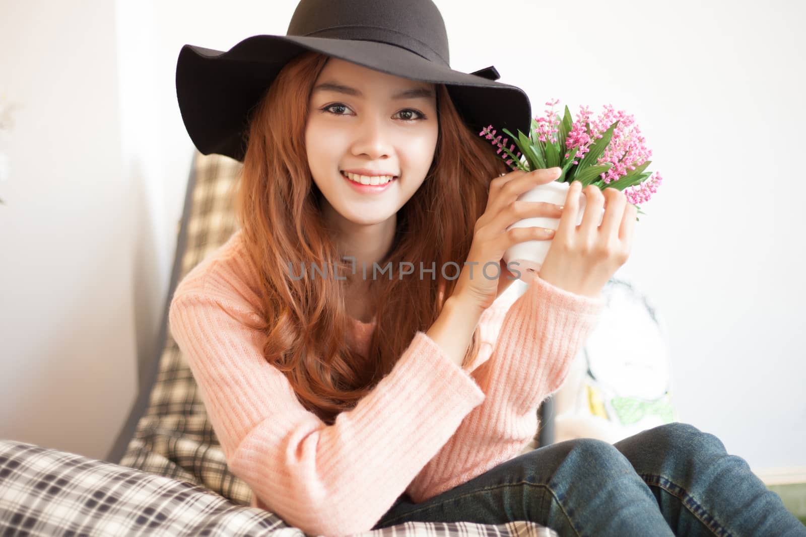Long haired asia girl happy smile with little flowers .