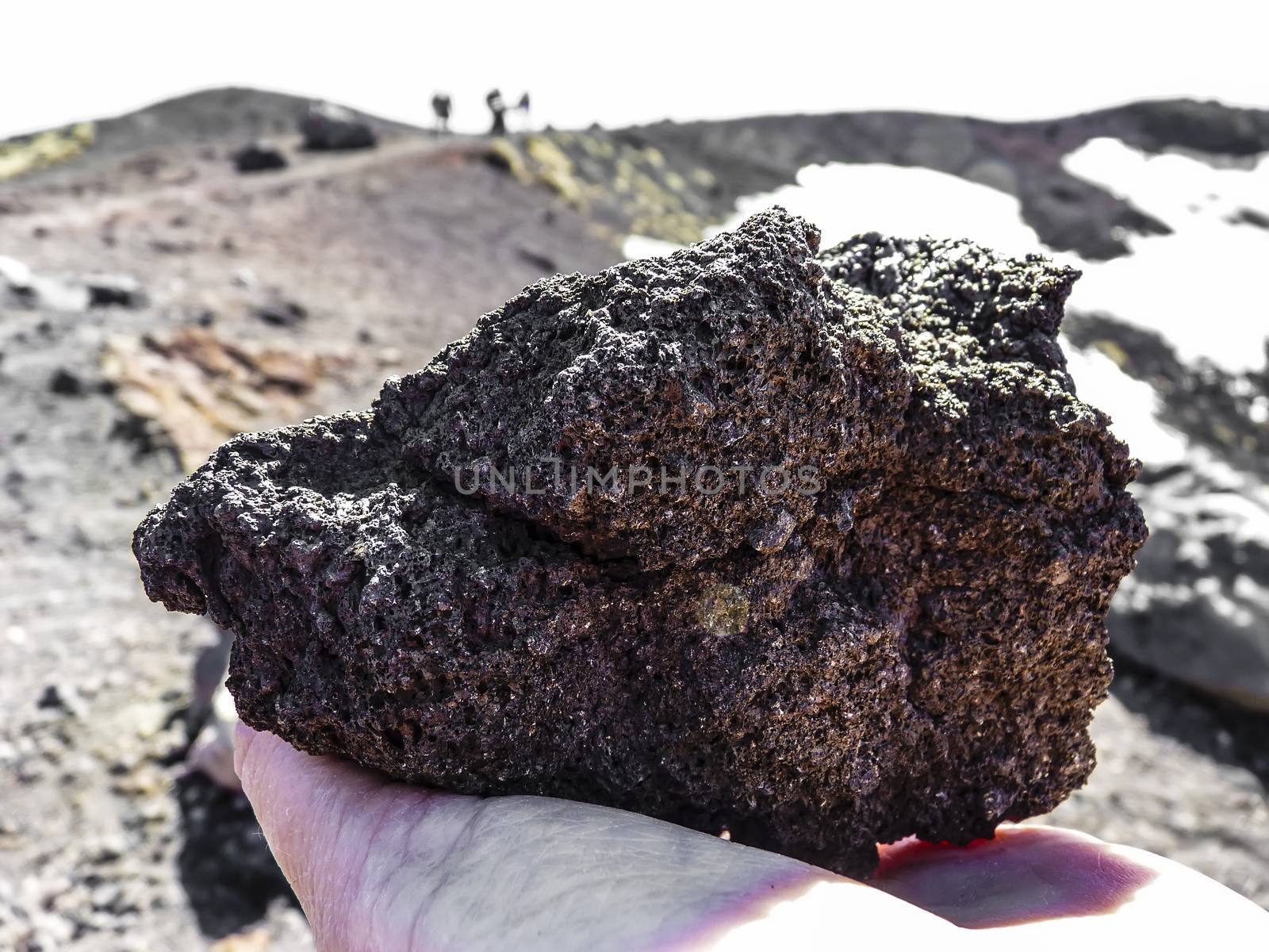 Volcanic rock in human hand at mount Etna, Sicily, Italy