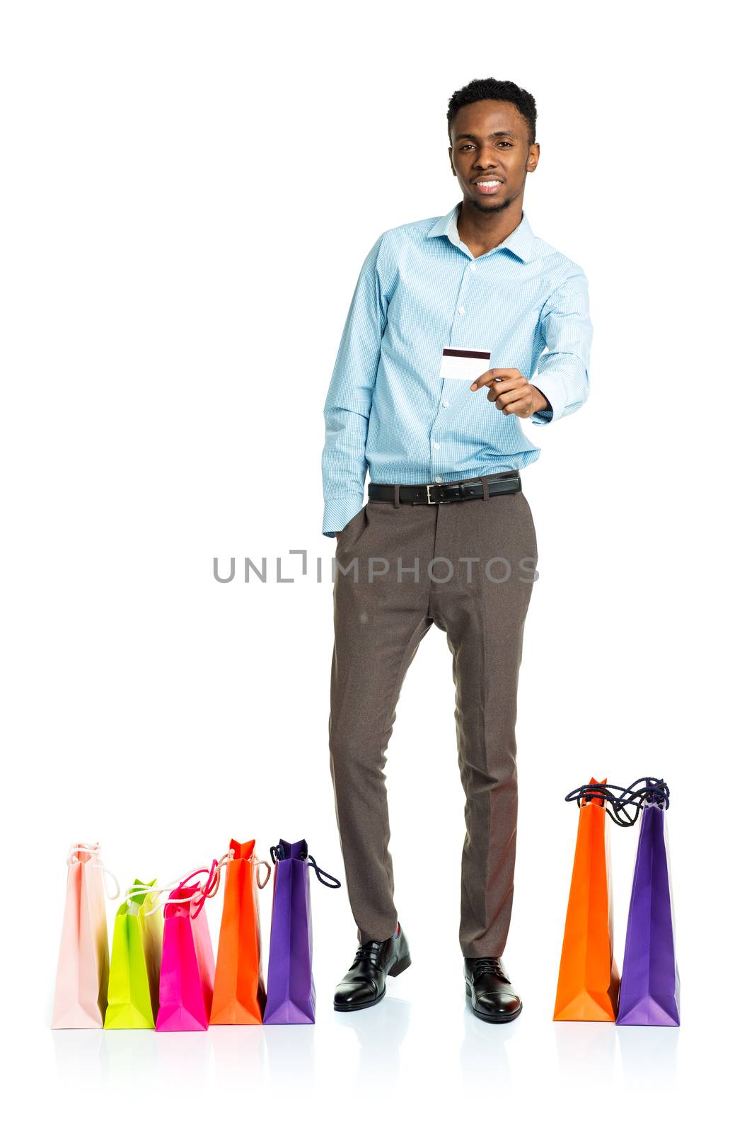 Happy african american man with shopping bags and holding credit by vlad_star