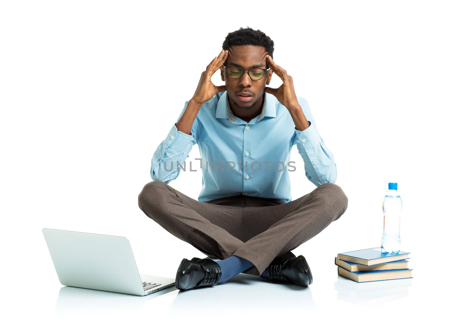 African american college student in stress sitting with laptop, books and bottle of water on white background