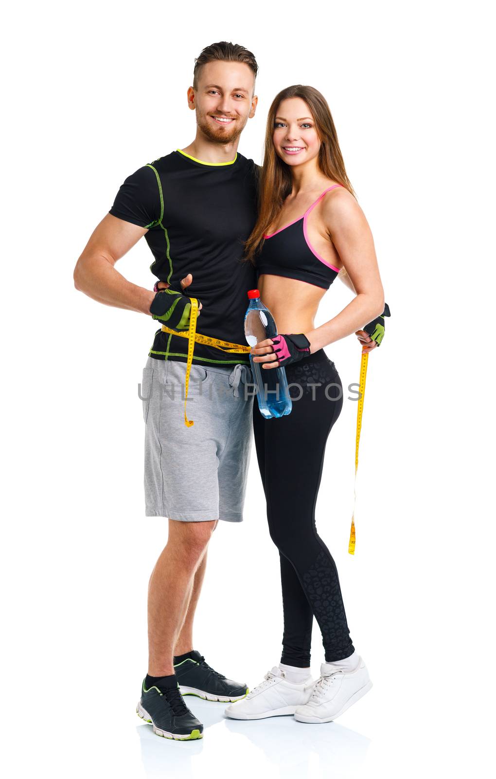 Happy athletic couple - man and woman with measuring tape on the by vlad_star