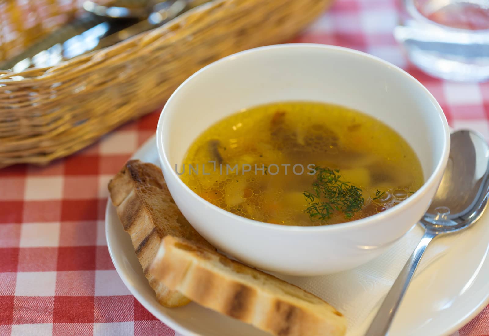 Vegetarian mushroom soup with vegetables and bread in white plat by vlad_star