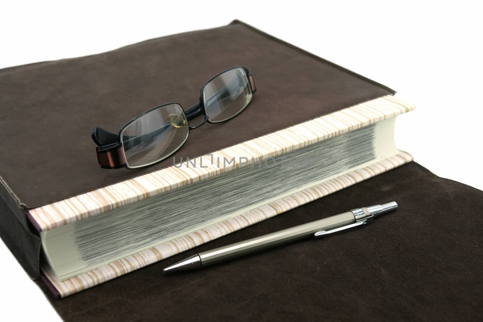 Old text book or bible with pen and eyeglasses and leather bag by mranucha