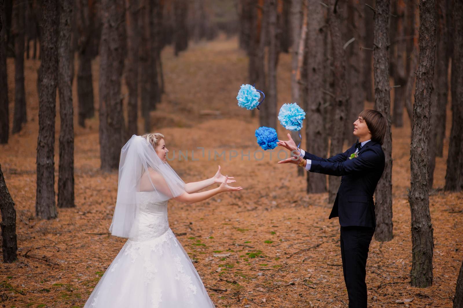 happy bride and groom walking in the autumn forest.