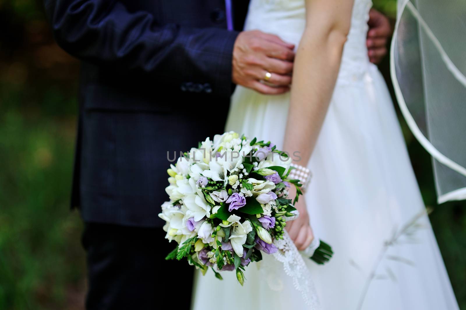 bride holding wedding bouquet and groom by timonko