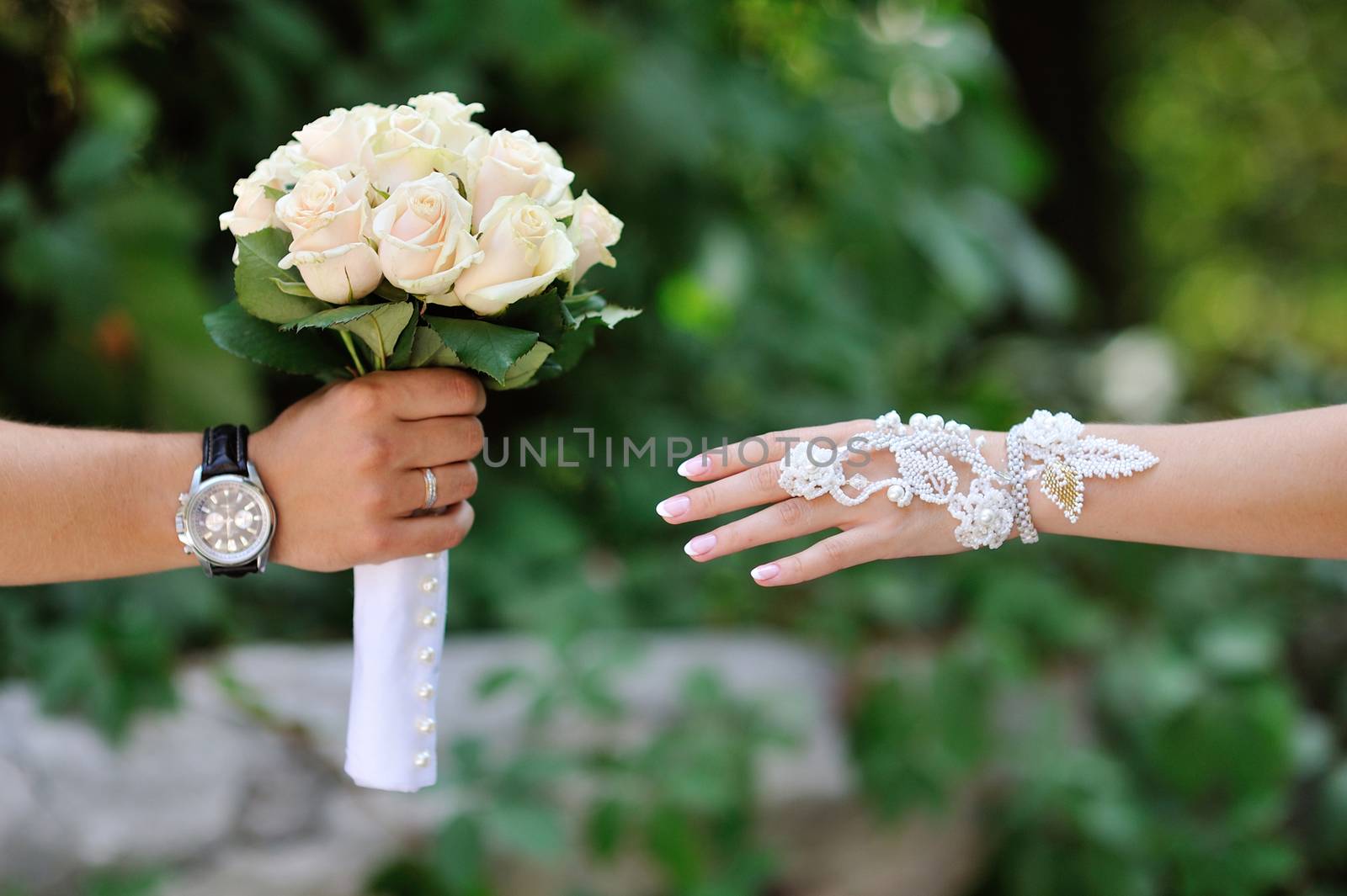 groom gives the bride a bouquet of roses.