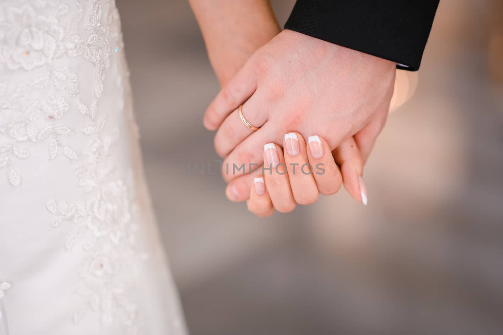 Bride and groom holding hands outdoors by timonko