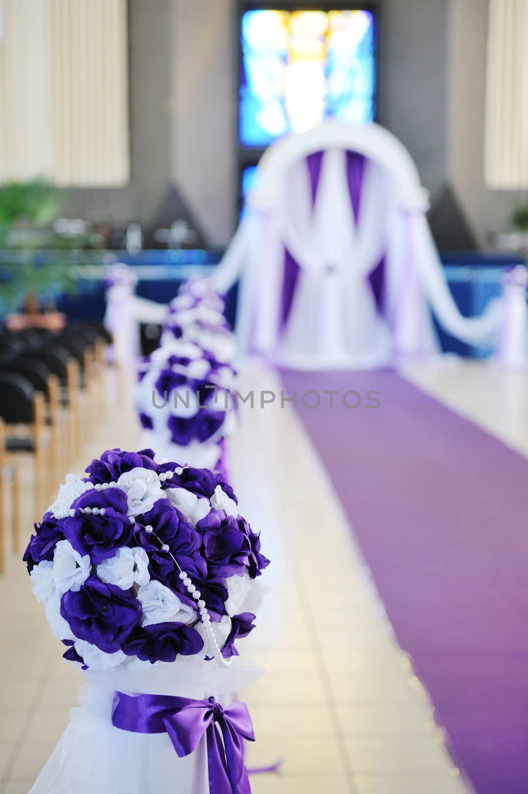 wedding arch and flowers in church