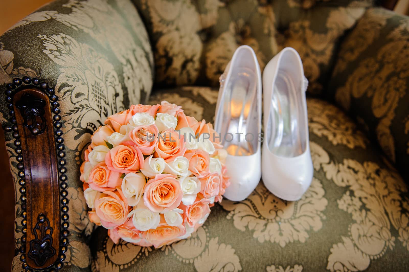 bridal bouquet and the bride shoes on chair