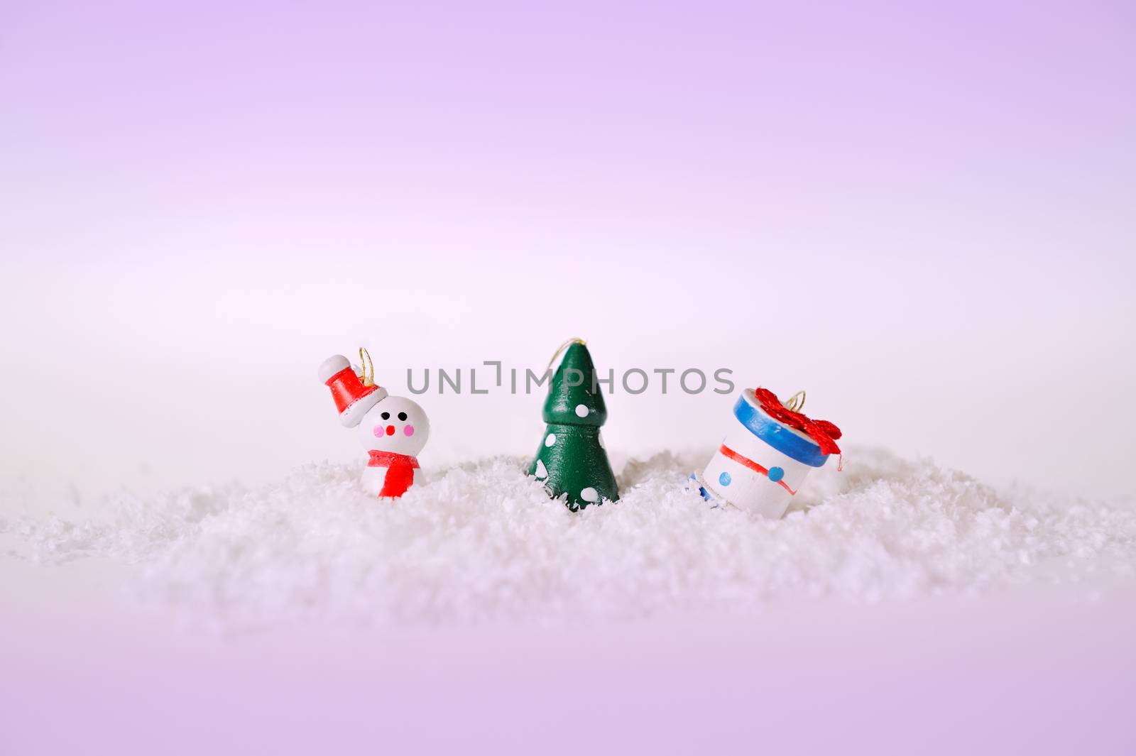 toy snowman tree and gift on snow