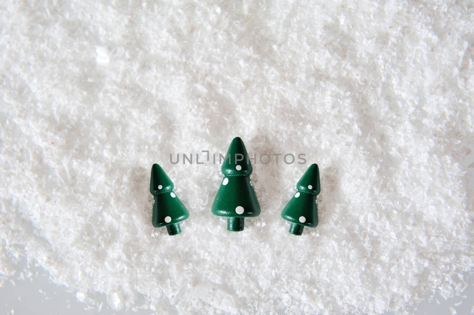 Three Miniature Christmas Trees on snow