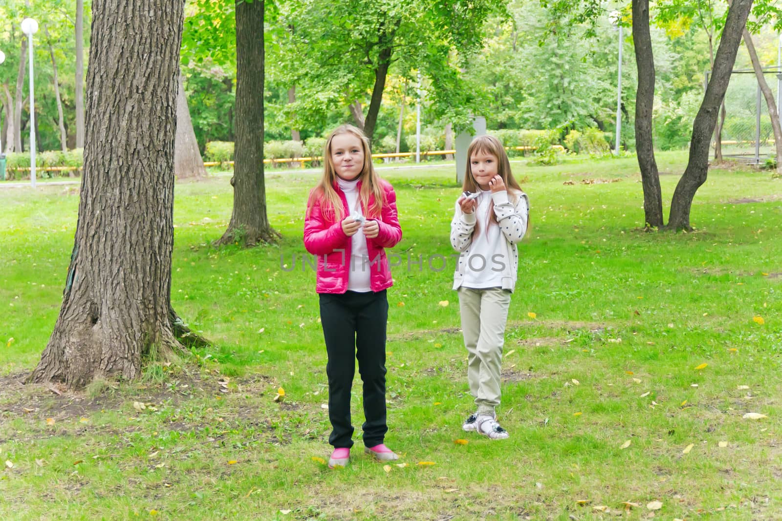 Photo of two eating girls in summer