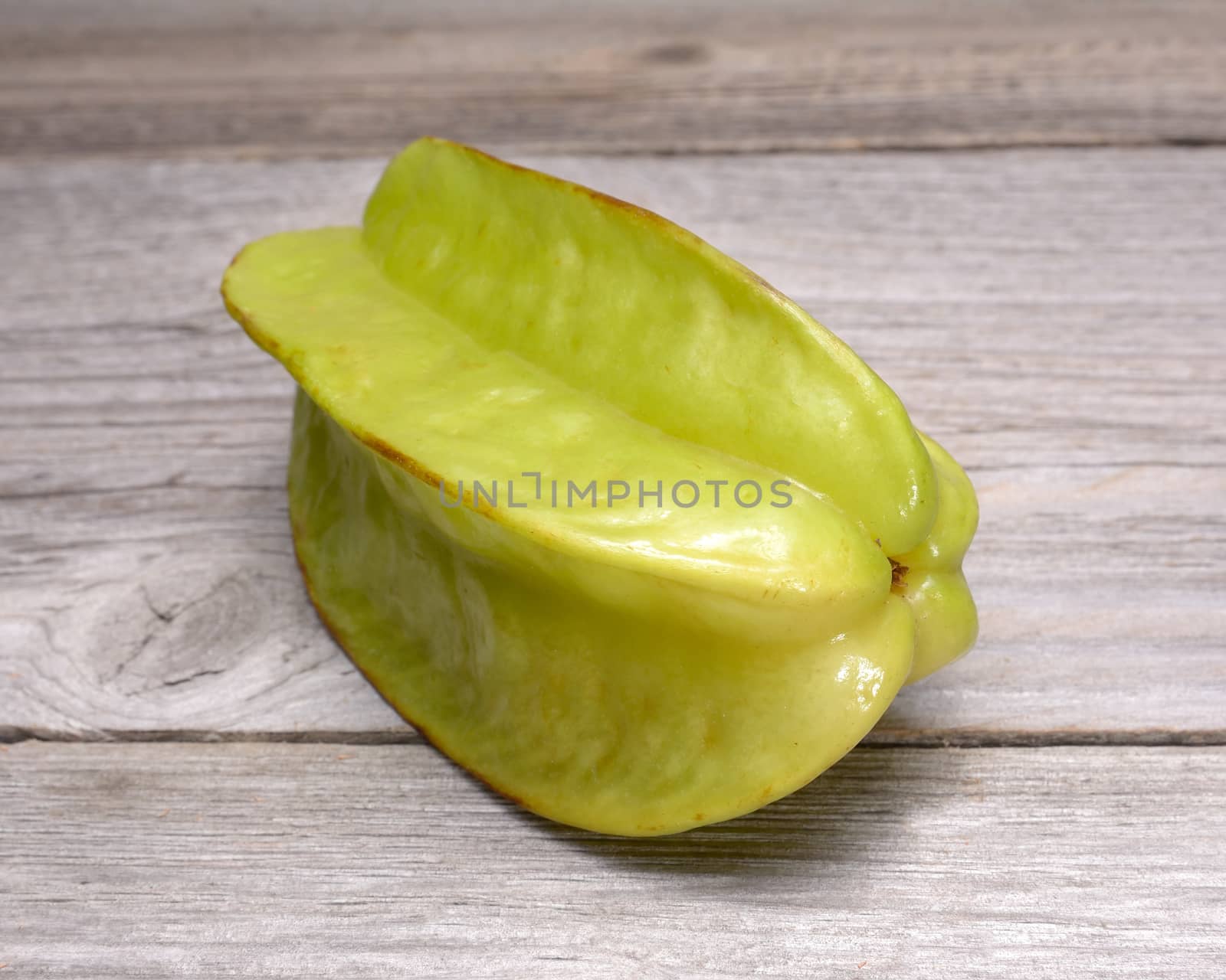 Star fruit - carambola isolated on wooden table by comet