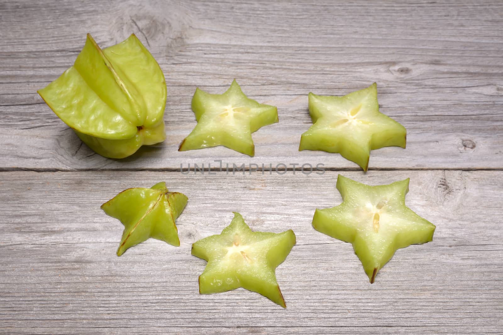 Star fruit - carambola isolated on wooden table by comet