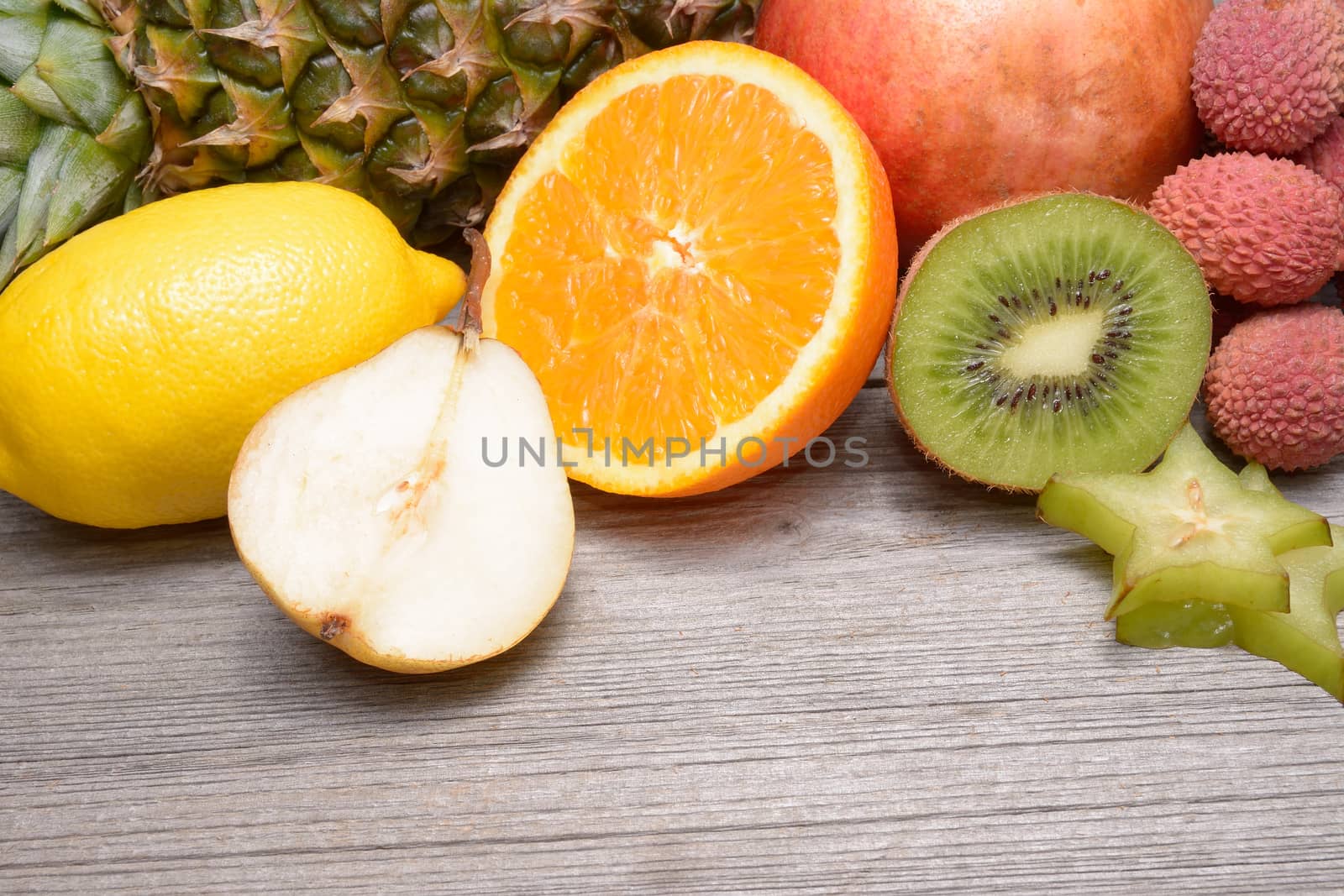 Exotic fruits on a wooden table by comet