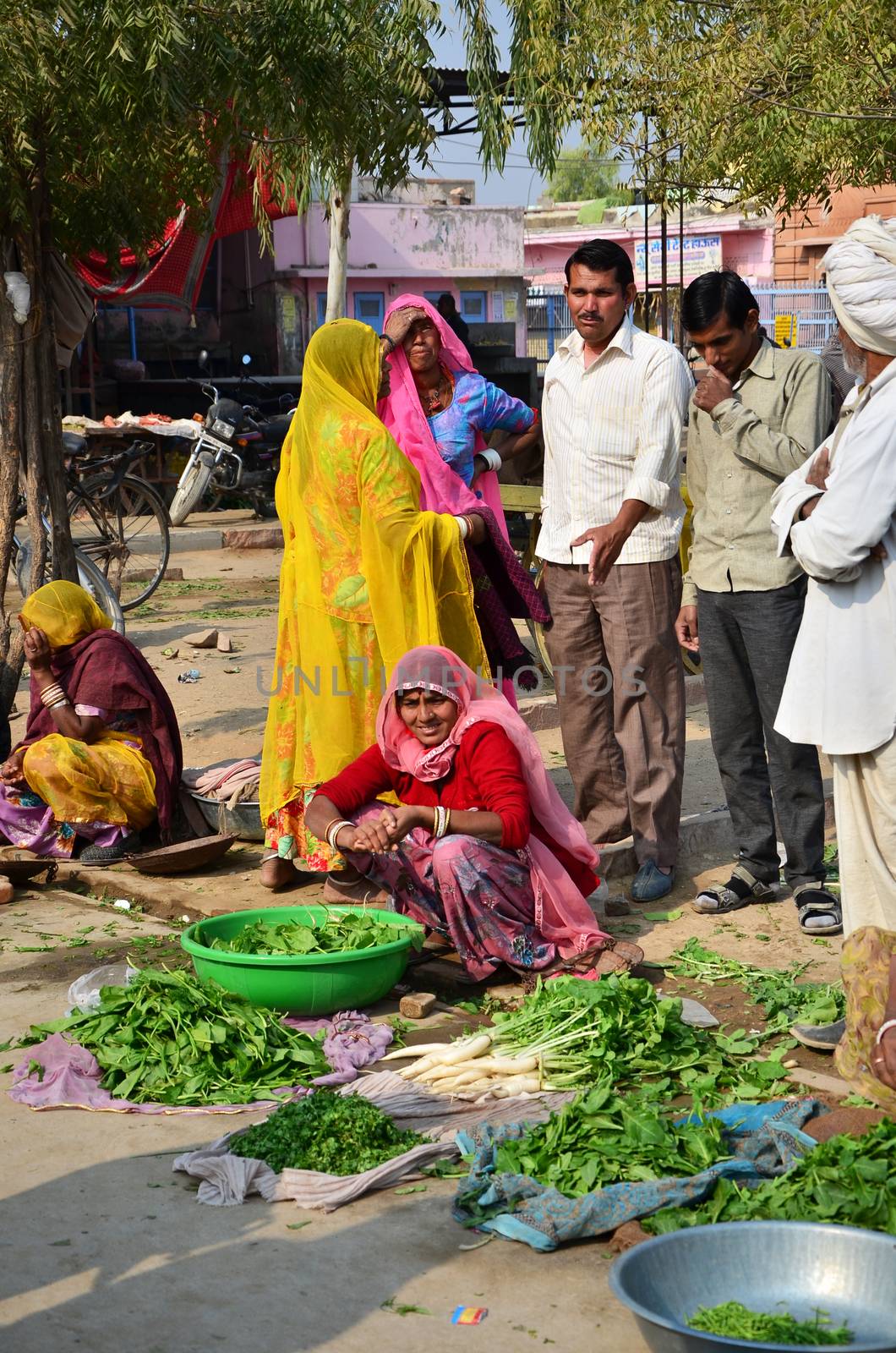 Jodhpur, India - January 2, 2015: Indian people shopping at typical vegetable street market in India on January 2, 2015 in Jodhpur, India. Food hawkers in India are generally unaware of standards of hygiene and cleanliness.