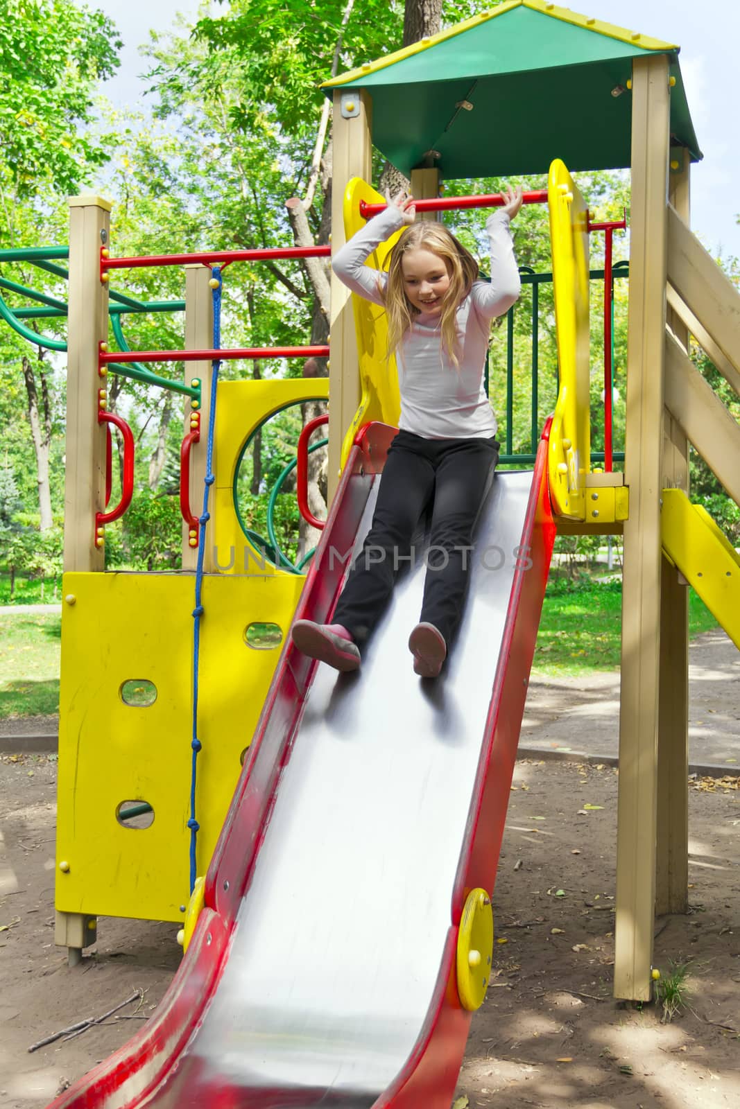 Active girl on nursery platform in summer by Julialine