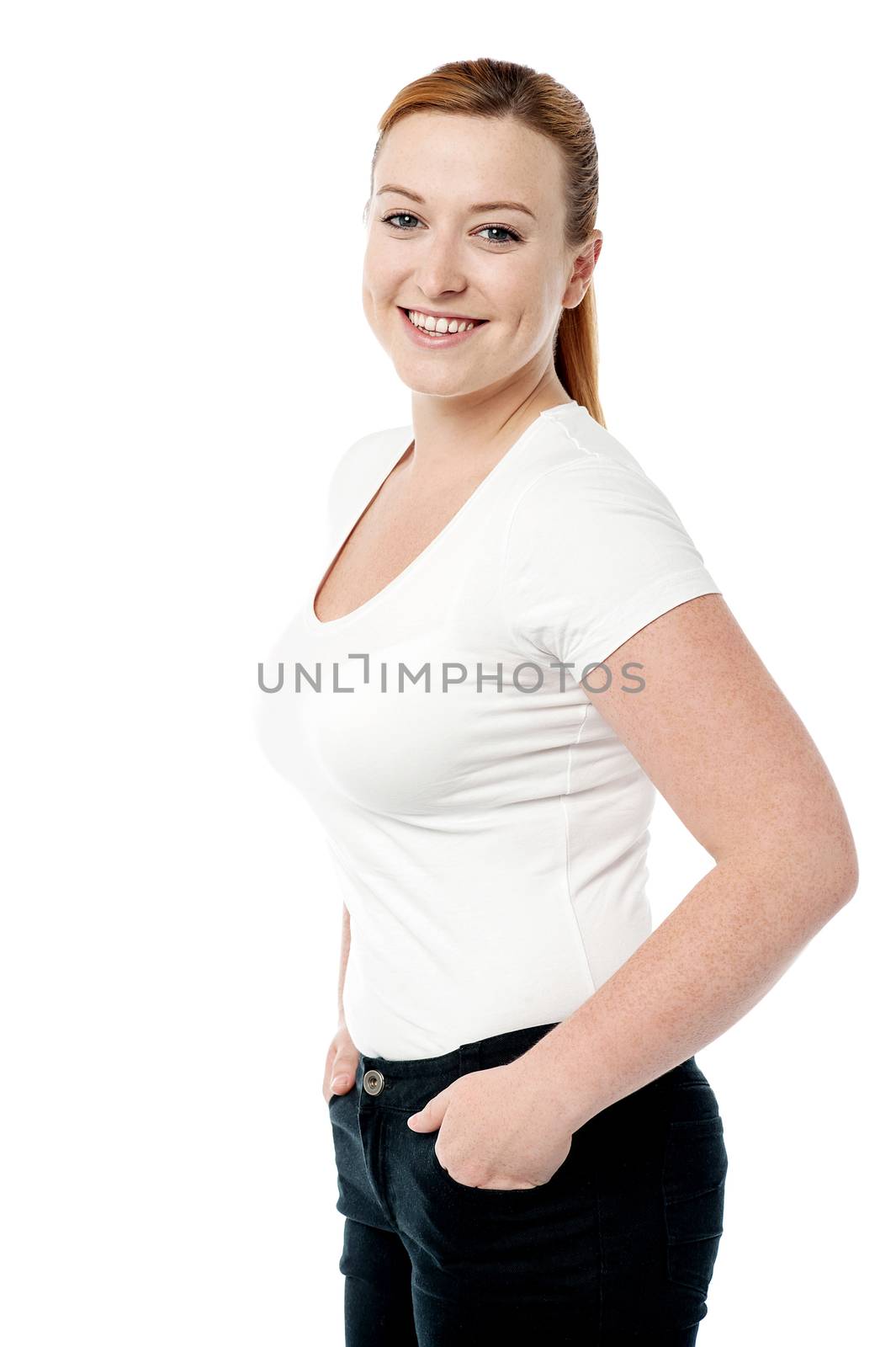 Happy woman standing with hands in pockets