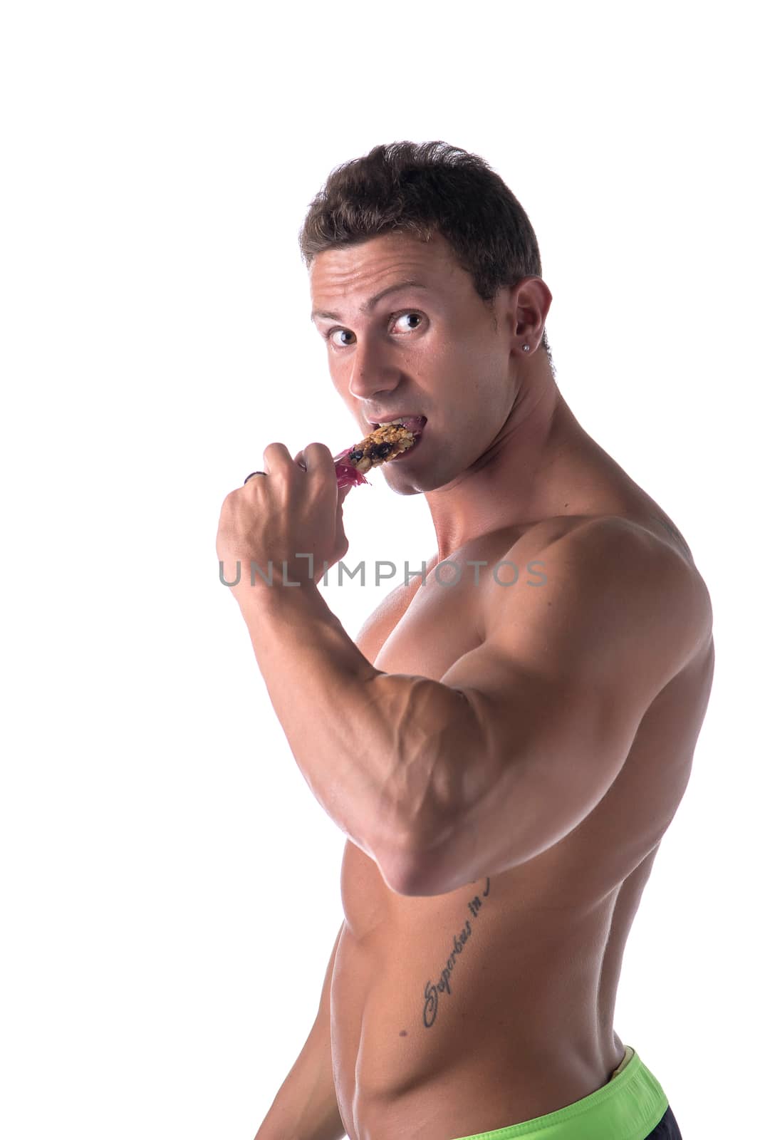 Shirtless muscular young man eating cereal bar by artofphoto