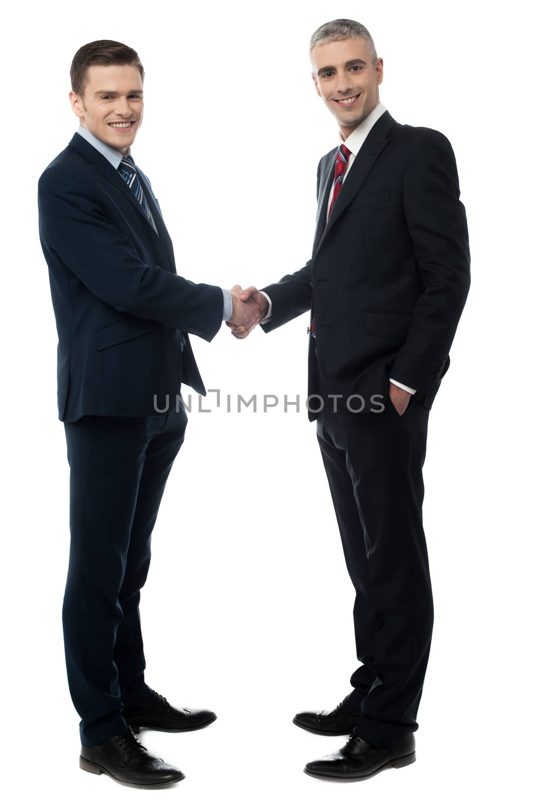 Happy business partners shaking hands