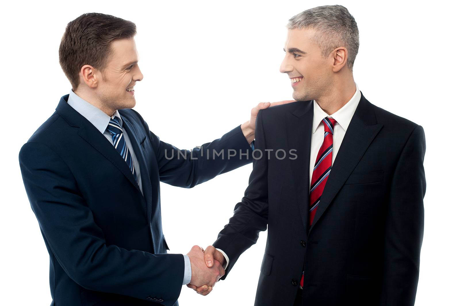 Happy young businessmen shaking hands