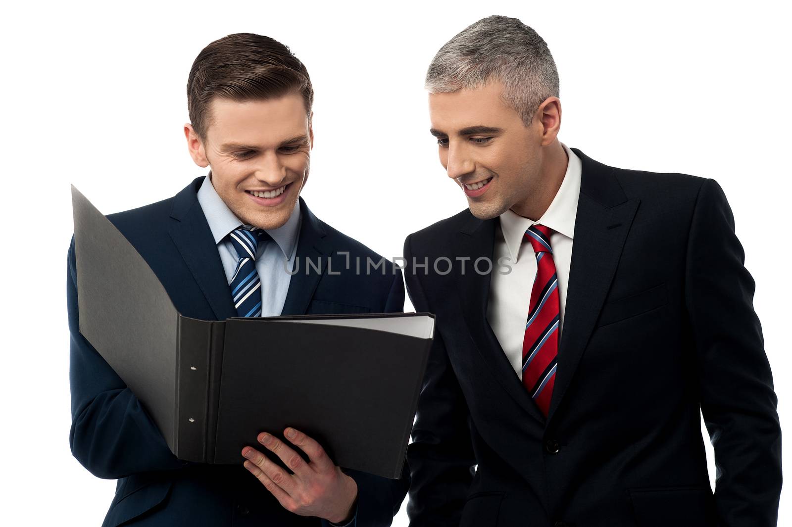 Happy business partners looking a file folder