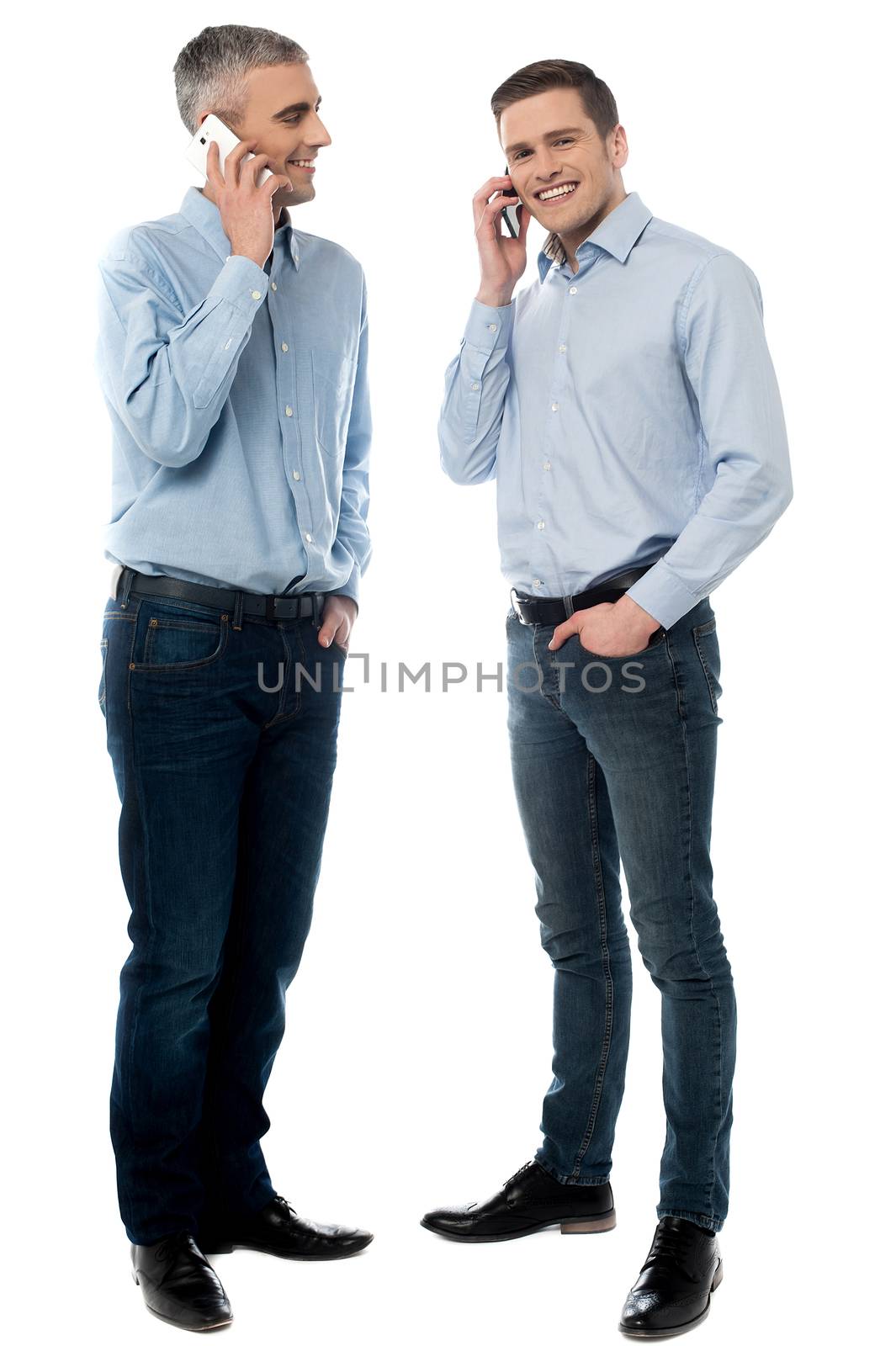 Happy young men communicate via cell phone