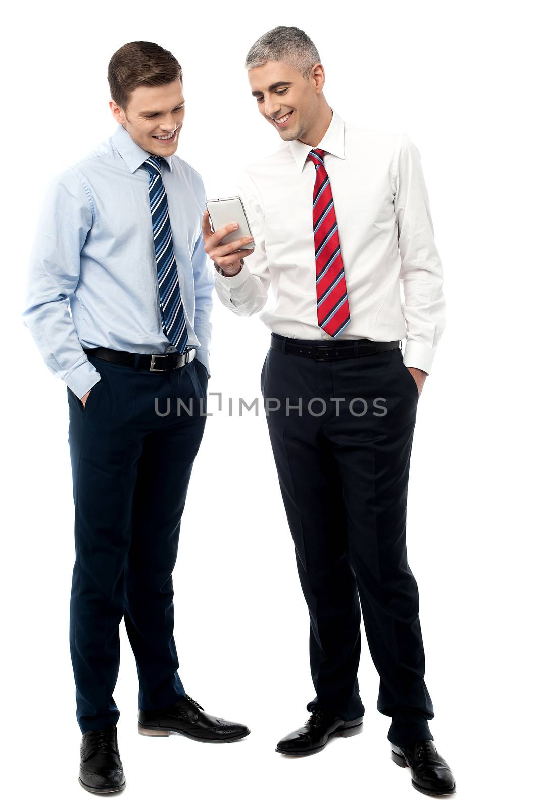 Two male business executives using smart phone