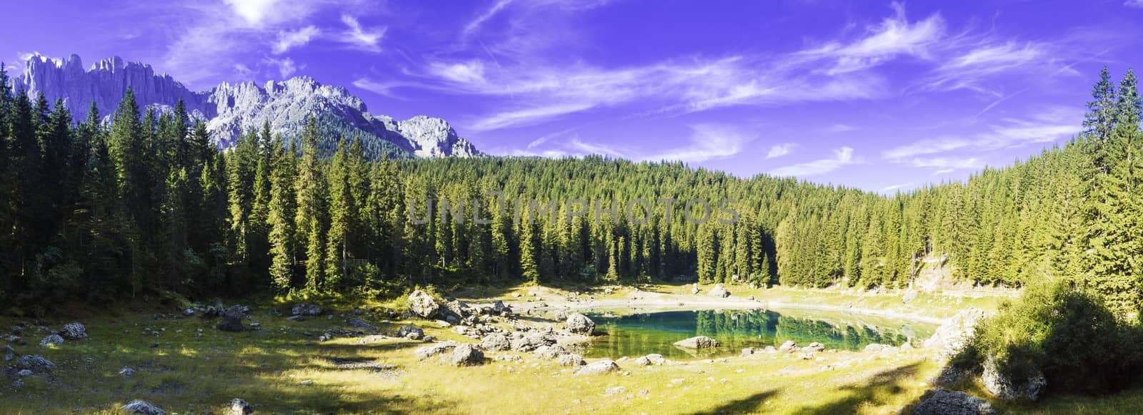 landscape and reflections in the famous lake of Carezza - Dolomites, Italy