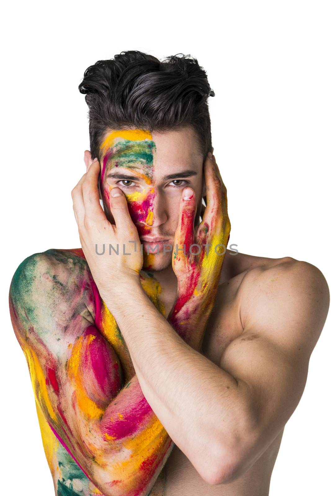 Attractive young man shirtless, skin painted all over with bright Holi colors isolated on white background