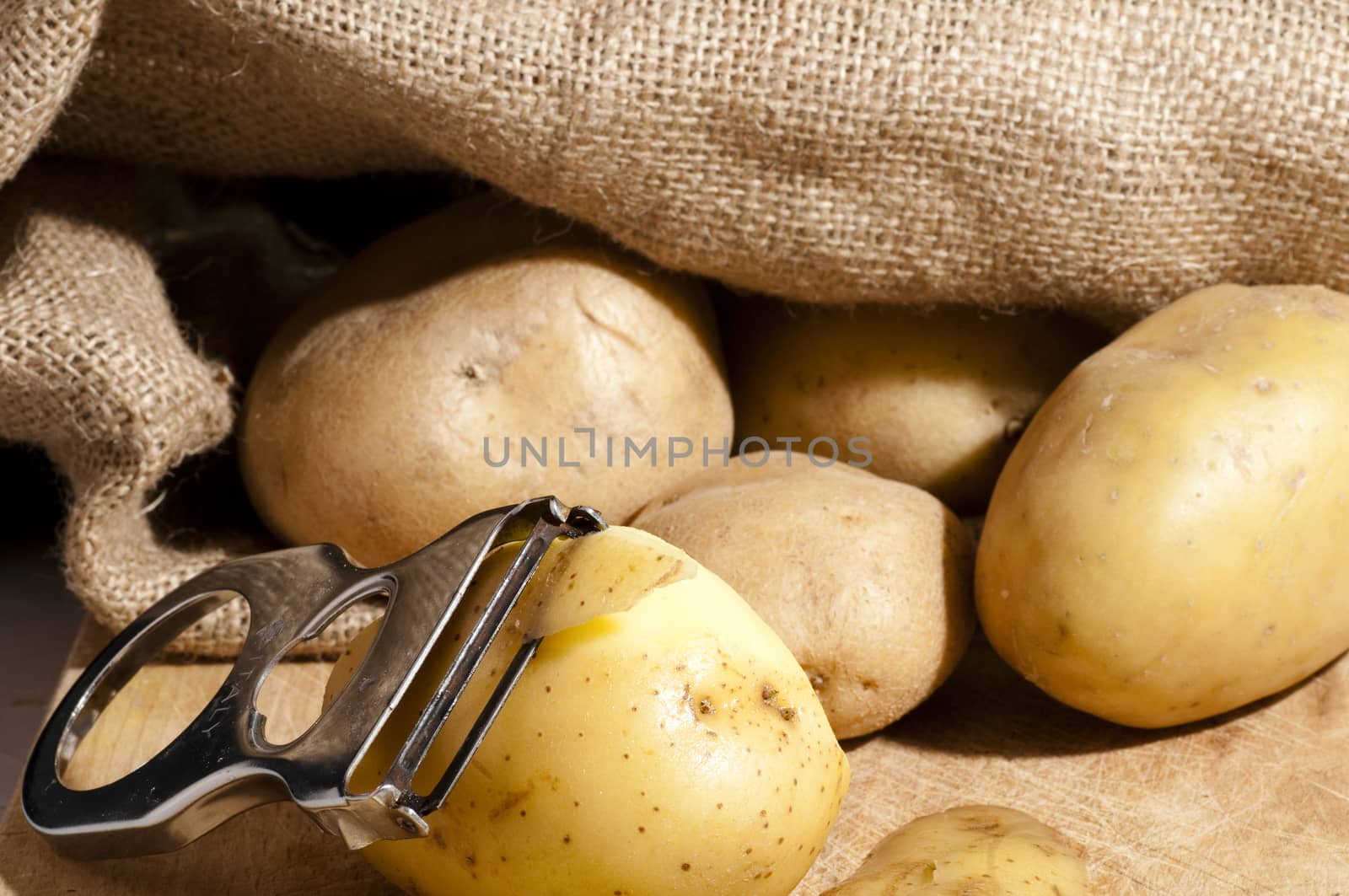 potatoes that are out of the jute bag ready to be peeled